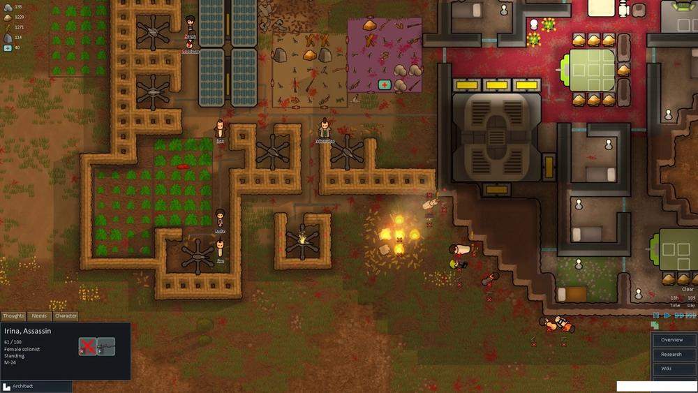Top-down RimWorld screenshot of a colony with fenced crop fields, solar panels and a red-floored base, with a fire burning near the entrance