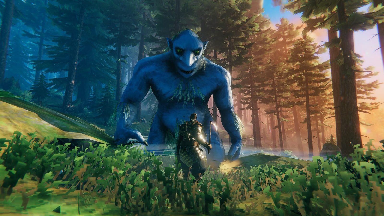 A large blue troll looms over an armoured Viking player in a sunlit pine forest in Valheim