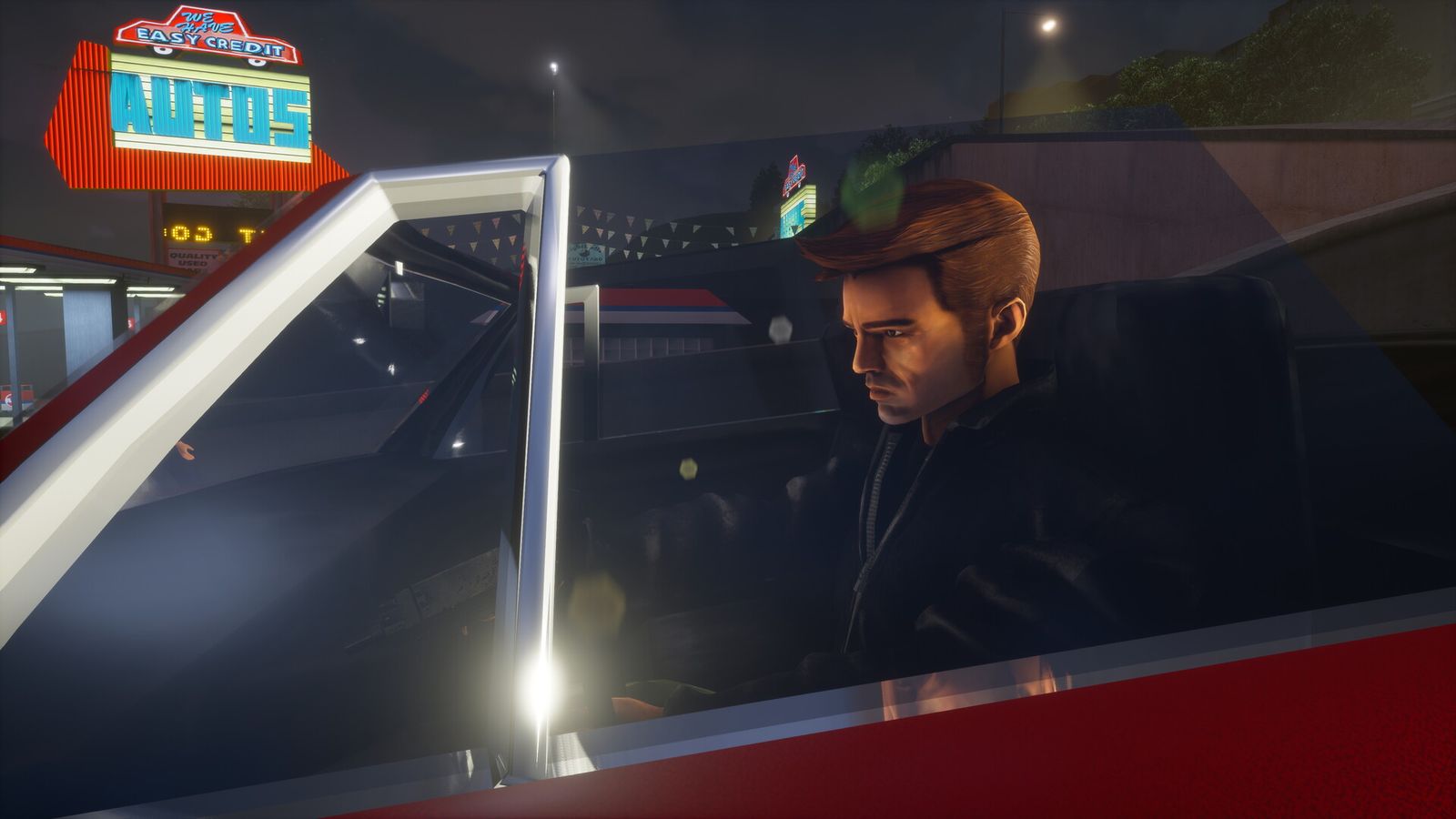 Claude, GTA III's silent protagonist, sits behind the wheel of a red car at night under a neon car-dealer sign