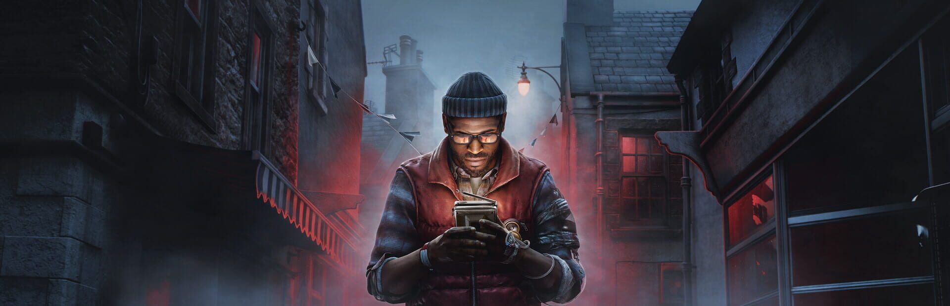 Simon Ordell in a beanie and glasses holding a handheld CRT television in a foggy street lit in red