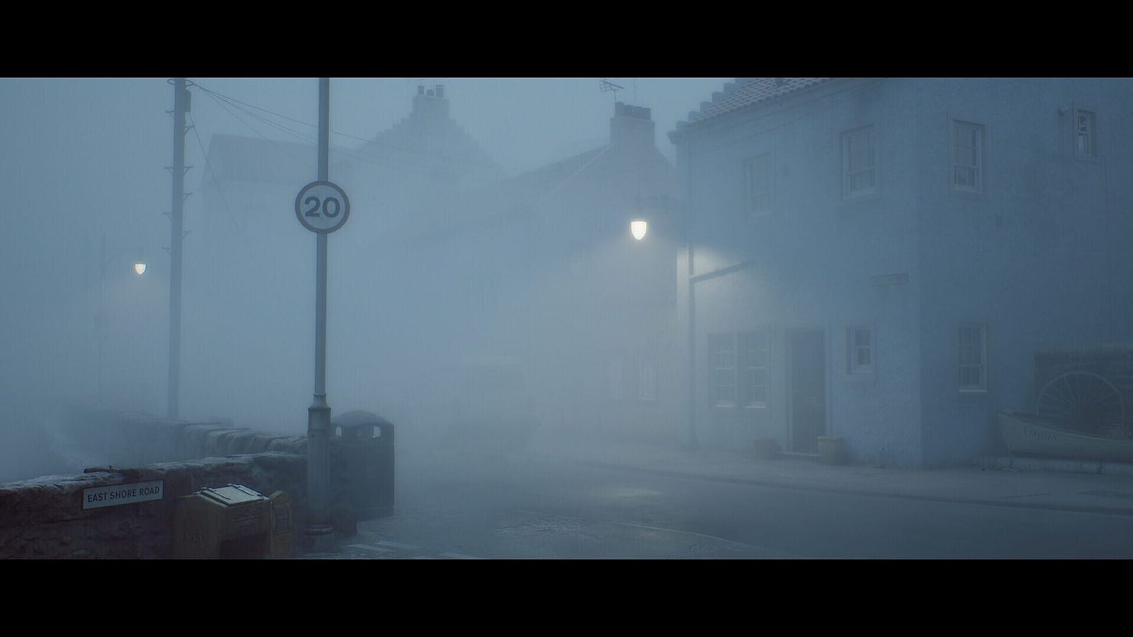 A fog-covered street in St. Amelia with a 20 speed-limit sign and a lit street lamp