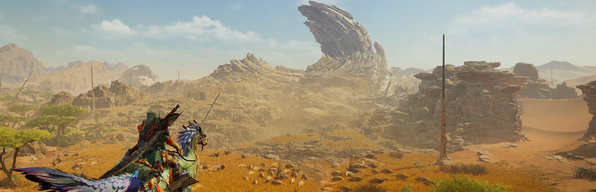 A hunter on a Seikret overlooking a vast desert basin in Monster Hunter Wilds