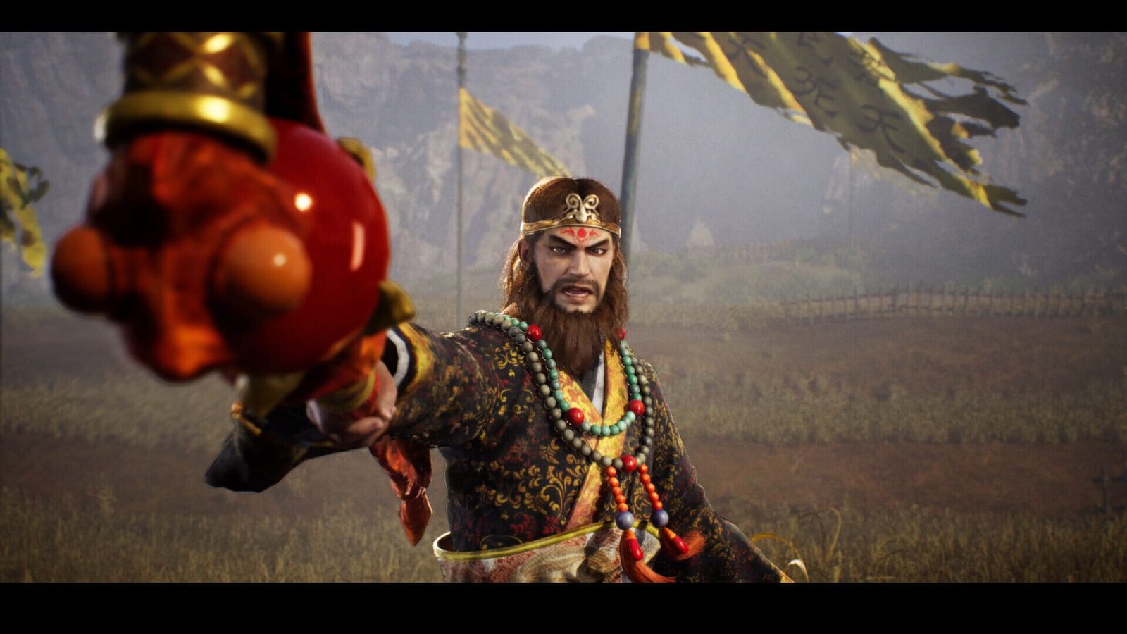 A bearded general in ornate armour points across a battlefield lined with yellow banners