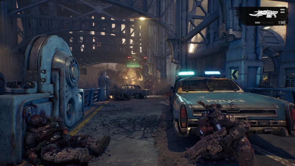 A COG soldier takes cover behind a police car on a ruined city street under a steel bridge in Gears of War: E-Day