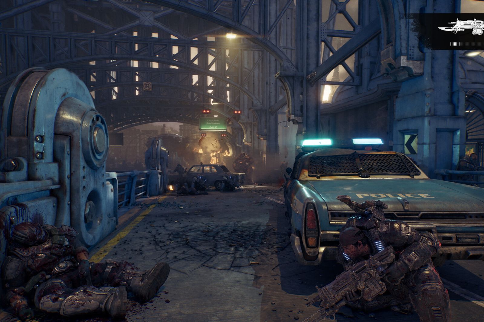 A COG soldier takes cover behind a police car on a ruined city street under a steel bridge in Gears of War: E-Day