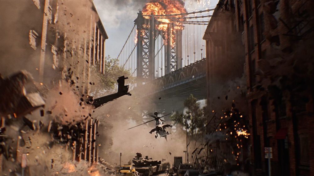 A helicopter flies through an exploding city street beneath a burning suspension bridge in Battlefield 6