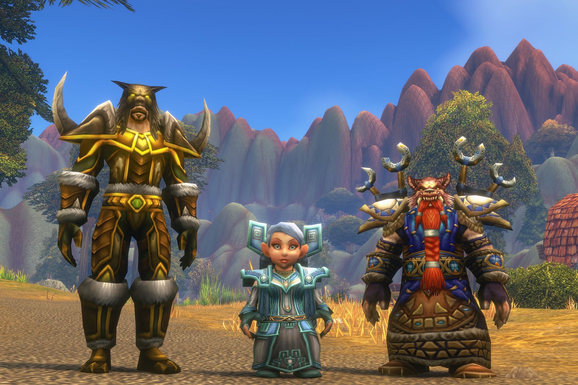 A tauren, a gnome and a dwarf in World of Warcraft: Forever standing on a dirt road in front of red mountains