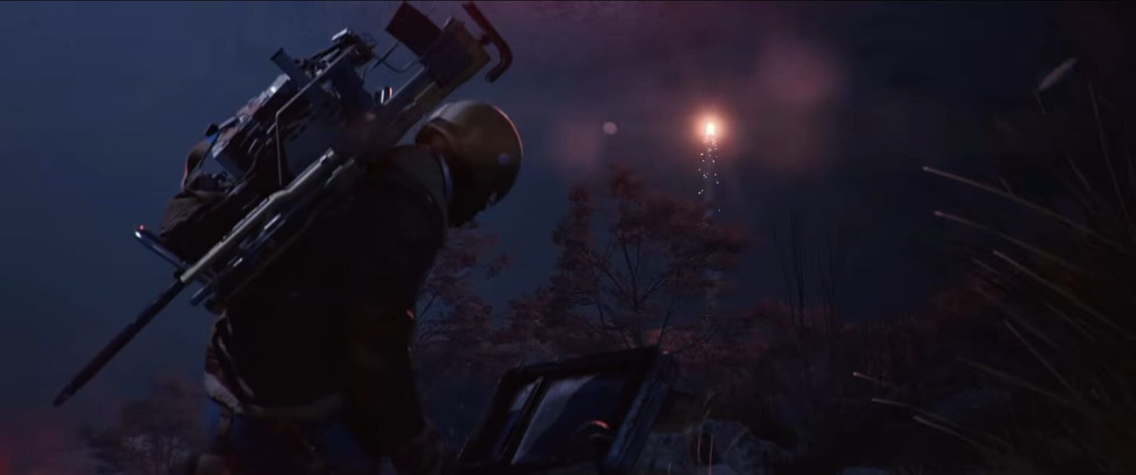 An armoured ARC Raiders character carrying a heavy weapon looks towards a flare burning in the distance at night