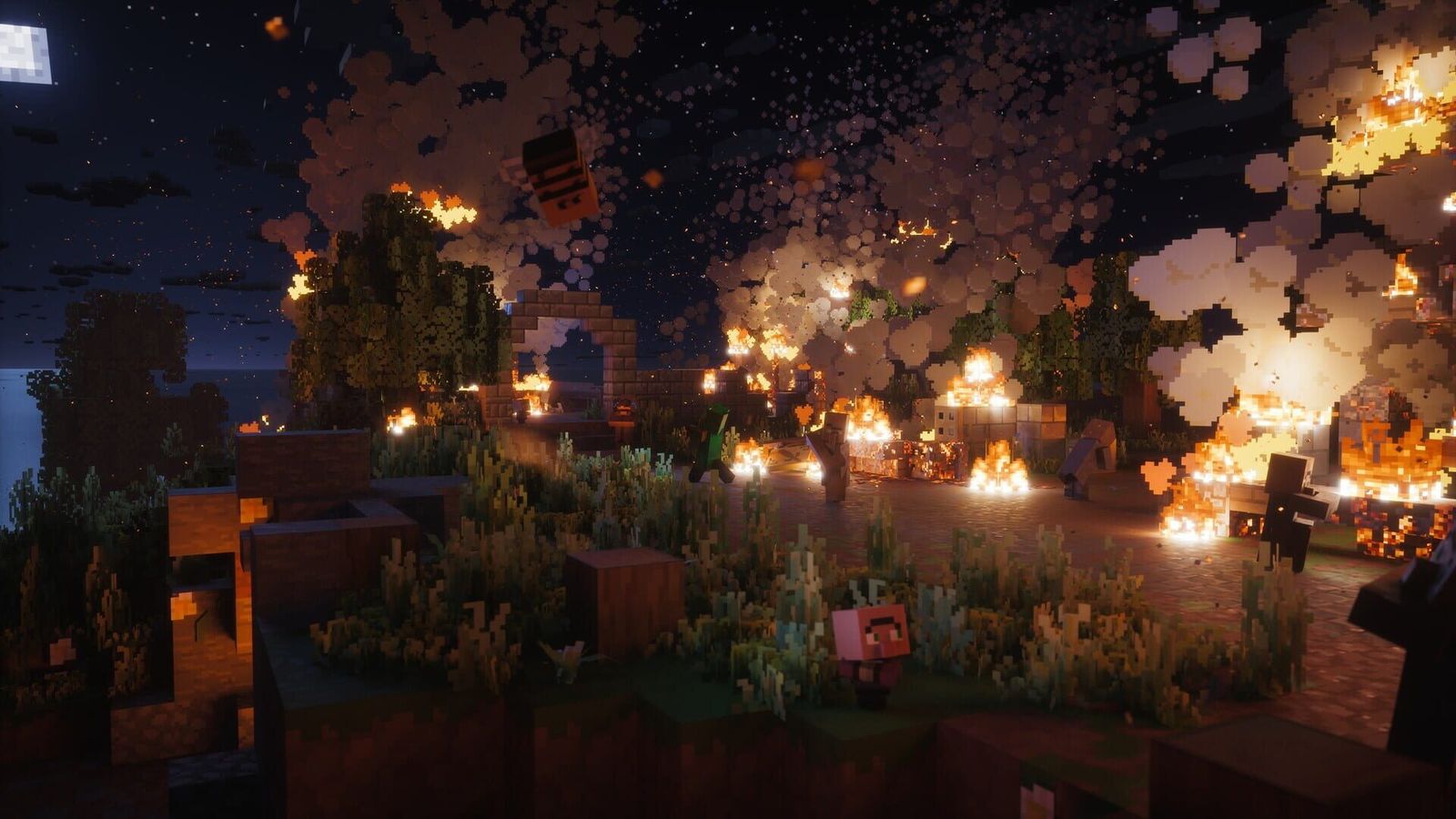 A blocky village at night with fires burning among trees and houses, and a lone figure in the foreground