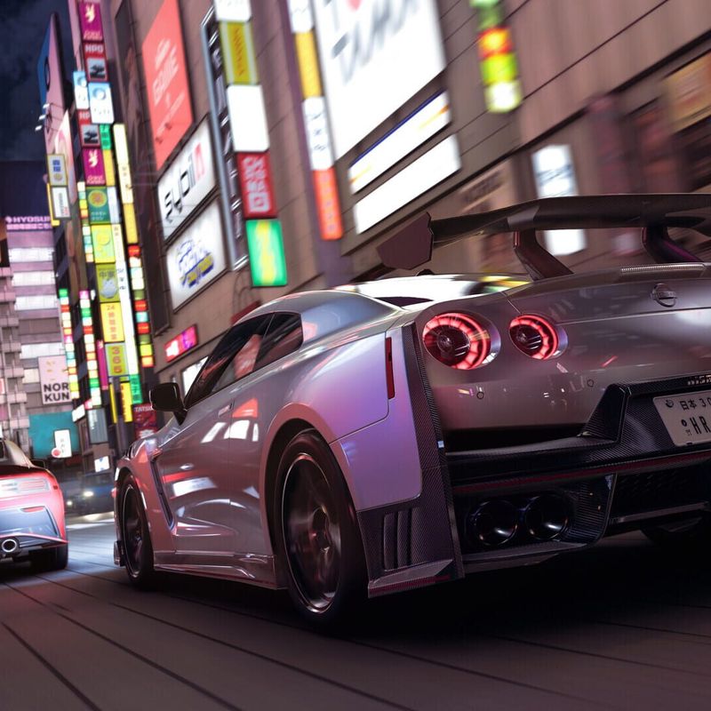 Silver GT-R racing down a neon-lit Tokyo street at night