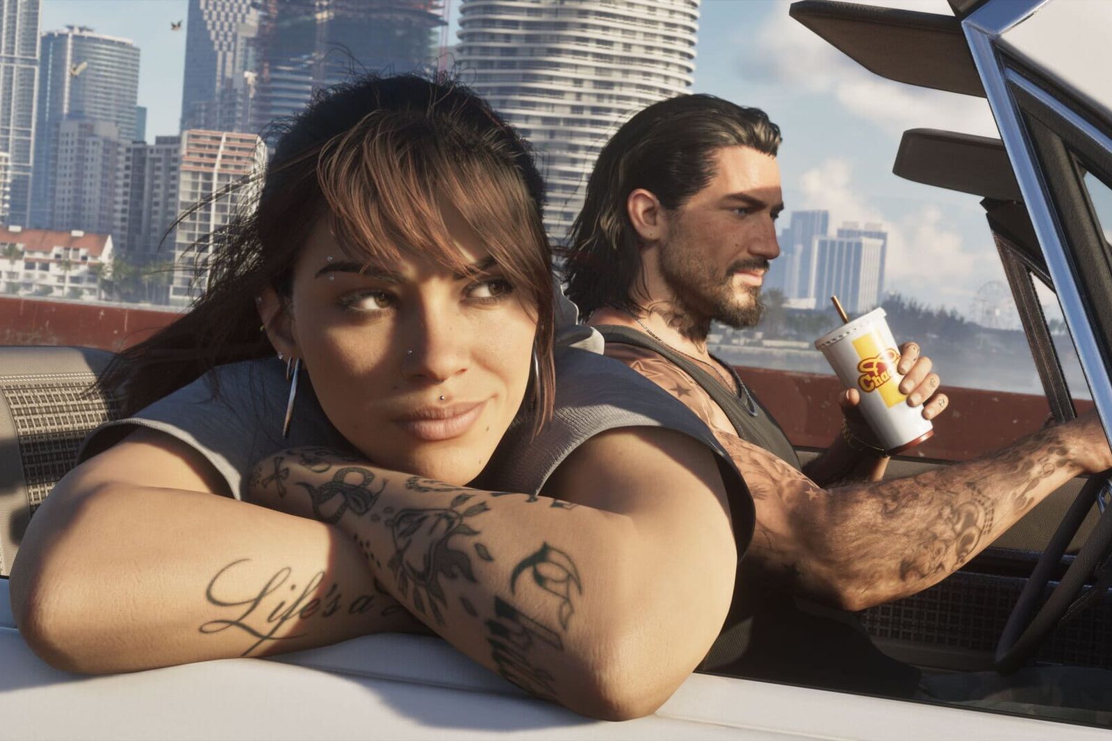 Lucia leans out of a convertible holding a drink cup while Jason drives past high-rise apartment towers