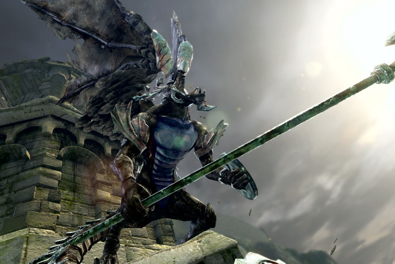 A winged armoured figure holding a long spear on a stone rampart under a grey sky in Dark Souls Remastered