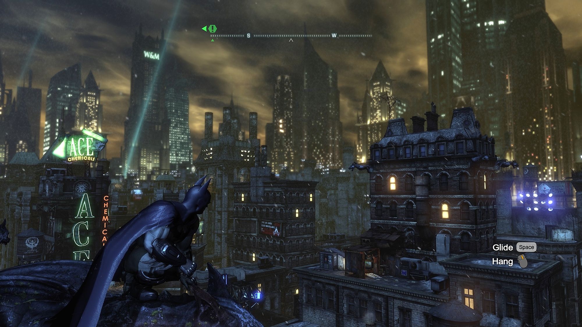 Batman crouched on a rooftop ledge overlooking the lit towers of Arkham City at night