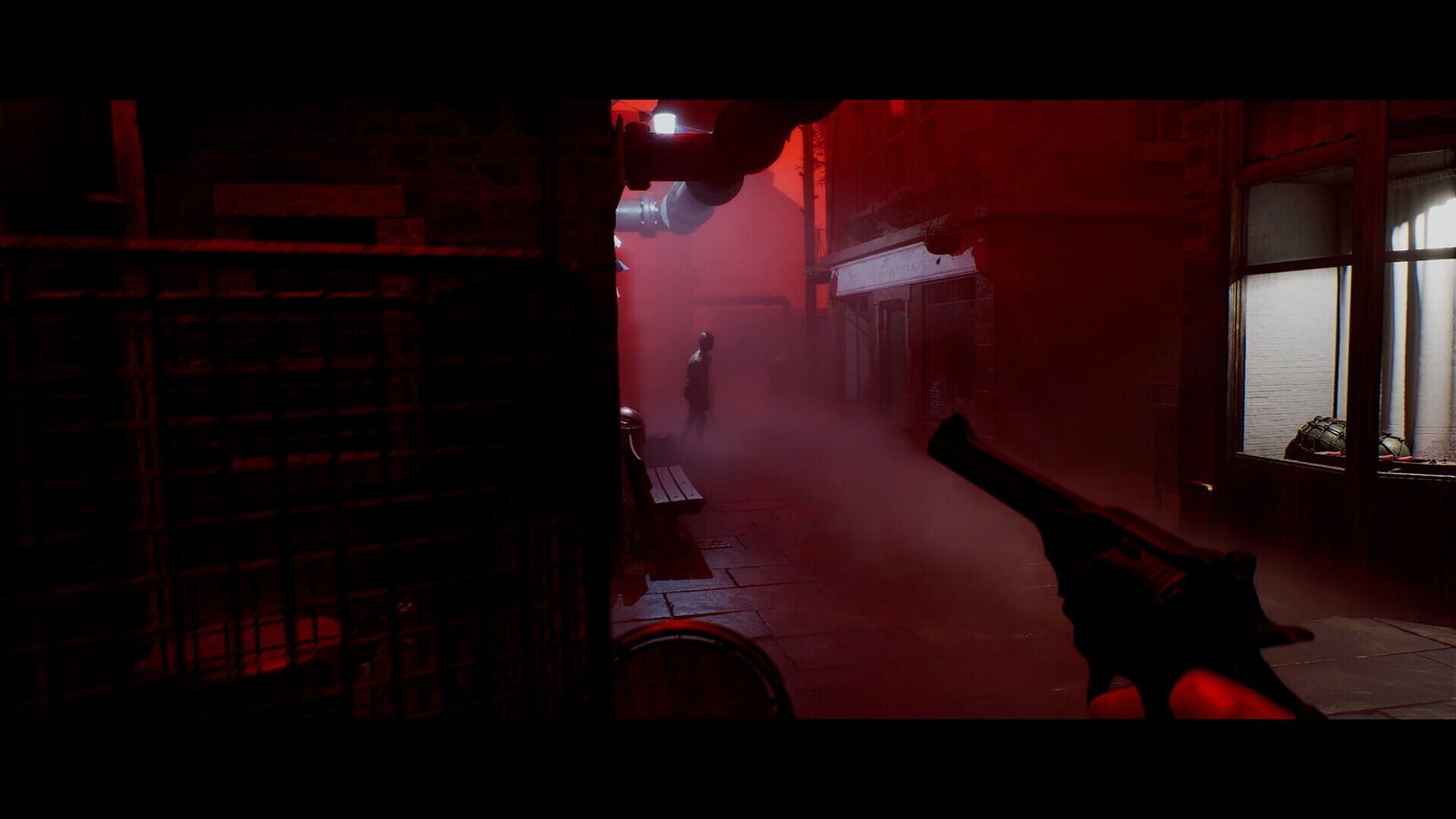 First-person view down a red-lit alley with a weapon held in the foreground, framed by black bars