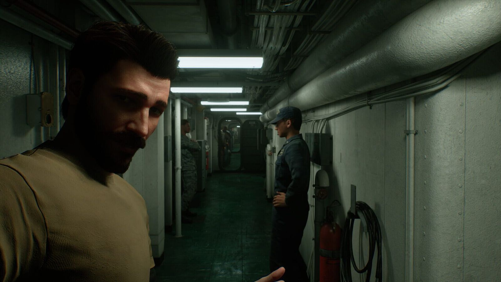 A pilot in a T-shirt gestures in a narrow ship corridor lit by ceiling lights while a crew member leans on the wall