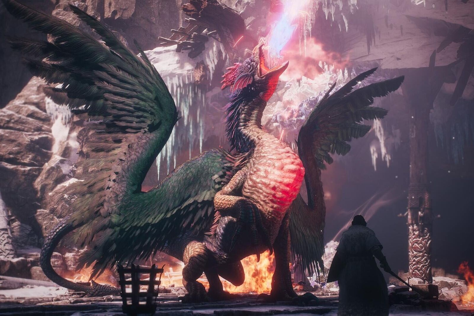 A winged beast with a feathered crest breathes fire in a ruined cave while a cloaked warrior stands in front of it