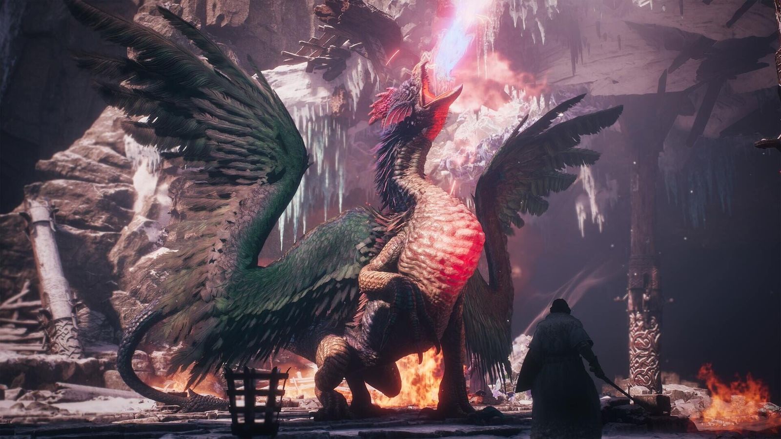 A winged beast with a feathered crest breathes fire in a ruined cave while a cloaked warrior stands in front of it