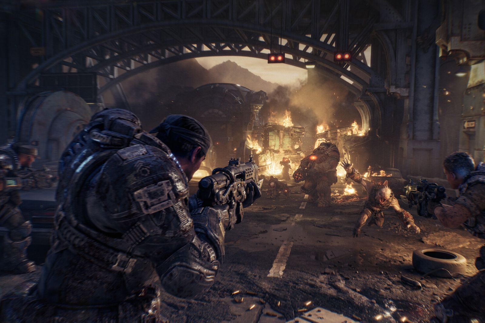Armoured COG soldiers crouch and fire rifles down a burning city street beneath a steel bridge