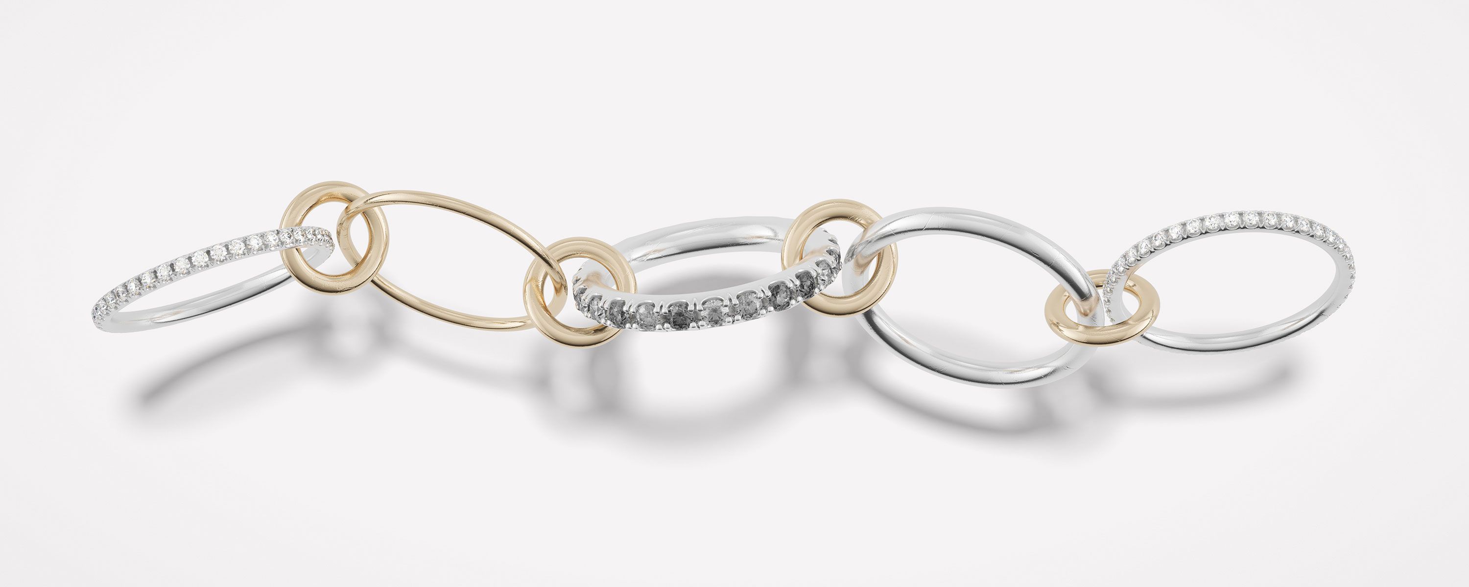 Spinelli Kilcollin image of the Aquarius linked ring spread across a white background with light shadow