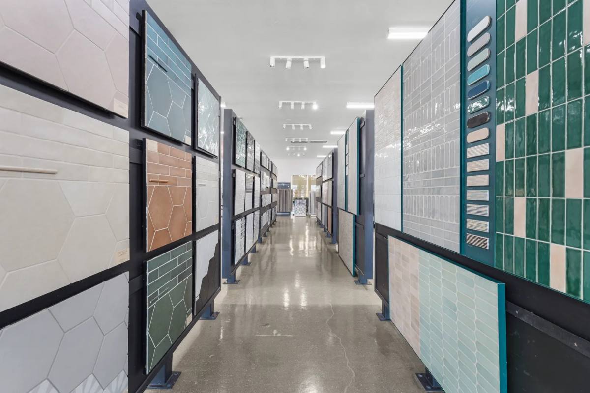 Large-format porcelain panels racked upright, floor to ceiling, in the SRQ Modern showroom