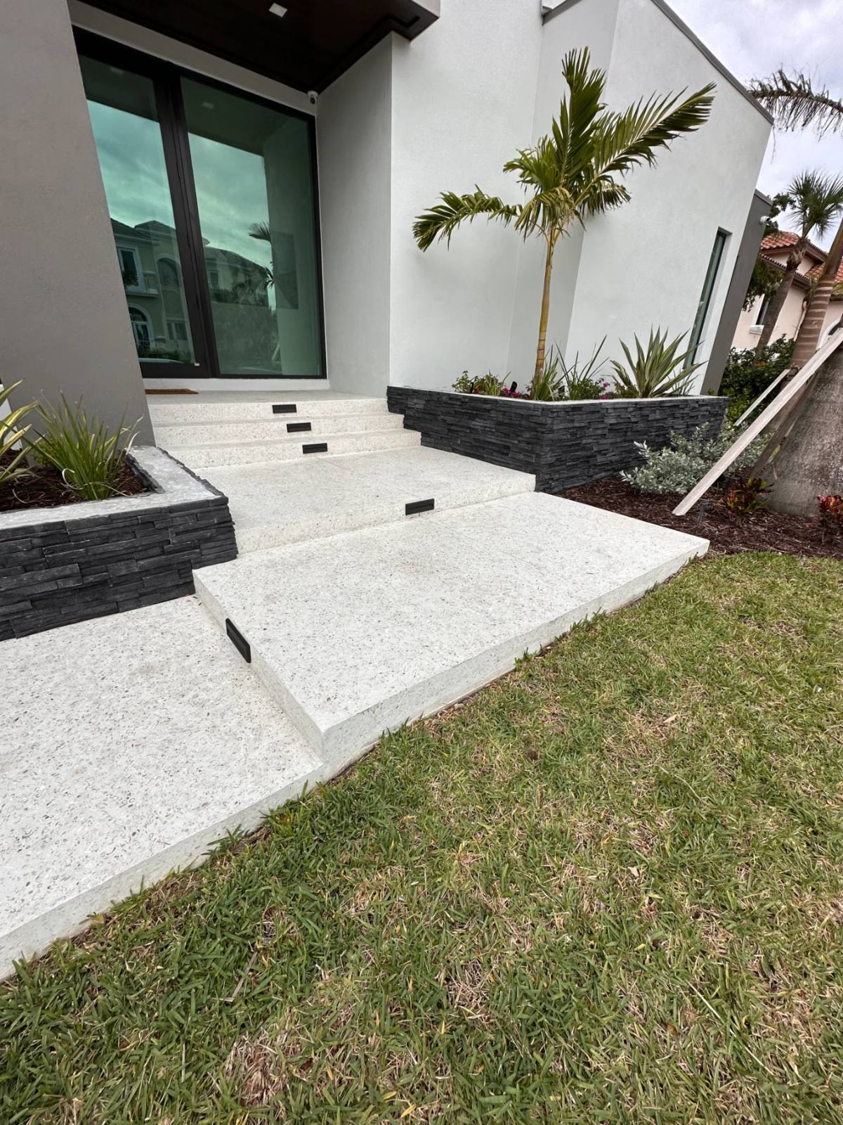 Shellcrete entrance steps seen from the side, mitred nosings and slab thickness visible in profile