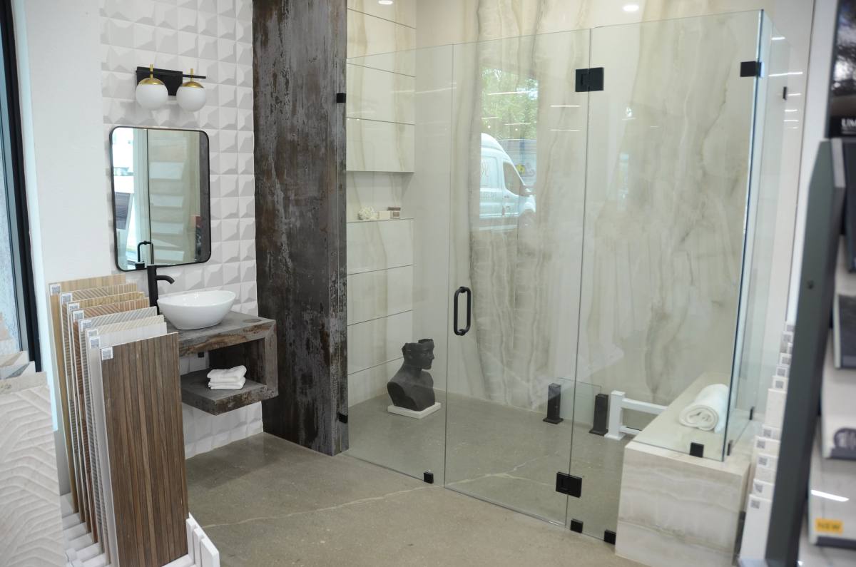 A tiled shower enclosure built as a full-size vignette in the showroom