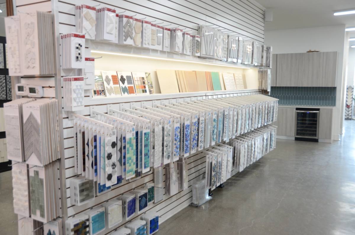 An aisle of manufacturer sample racks running the length of the Bradenton showroom