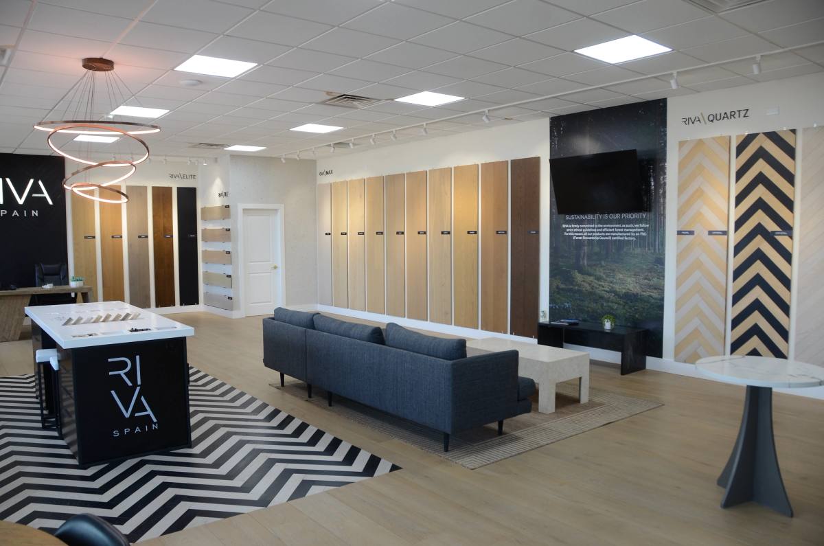 The Riva Spain gallery interior — wide-plank wood displays above a chevron rug