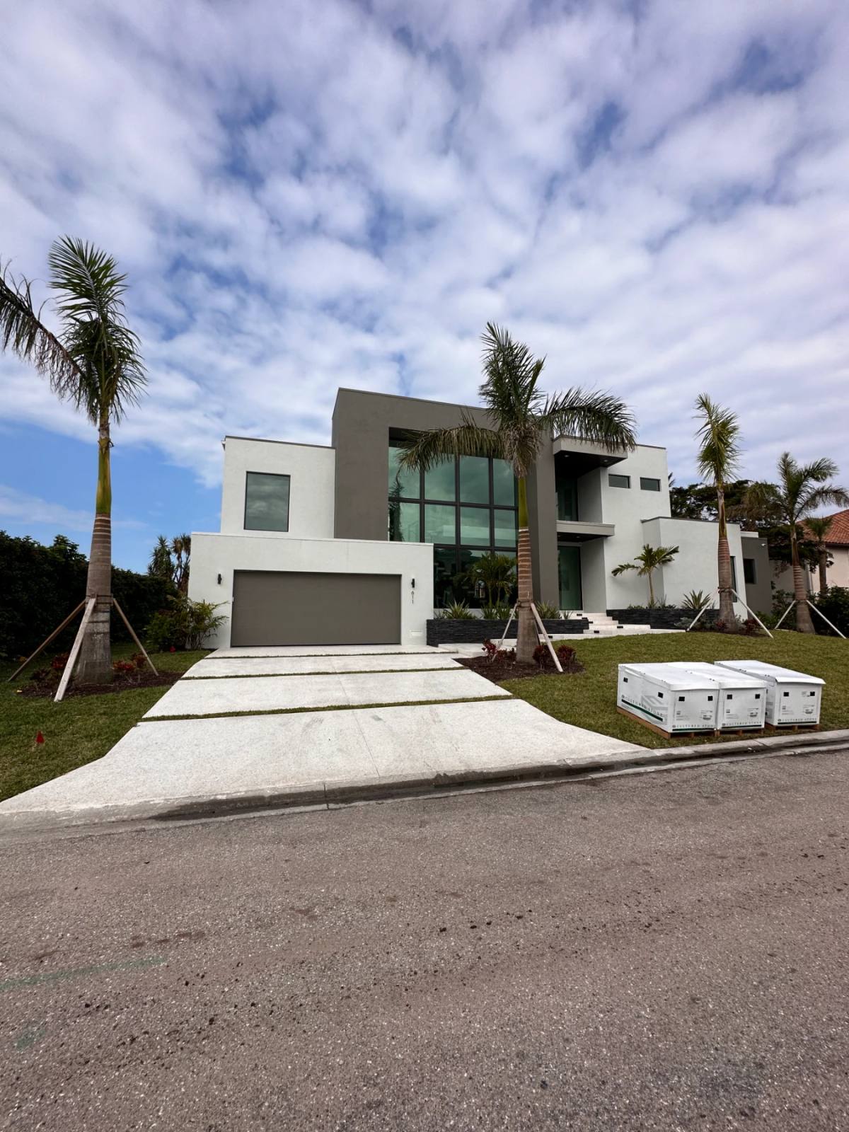 A modern two-storey house with a Shellcrete driveway divided into bands
