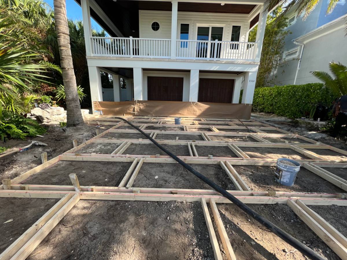 Timber formwork set out in a grid across a sand sub-base before a Shellcrete pour