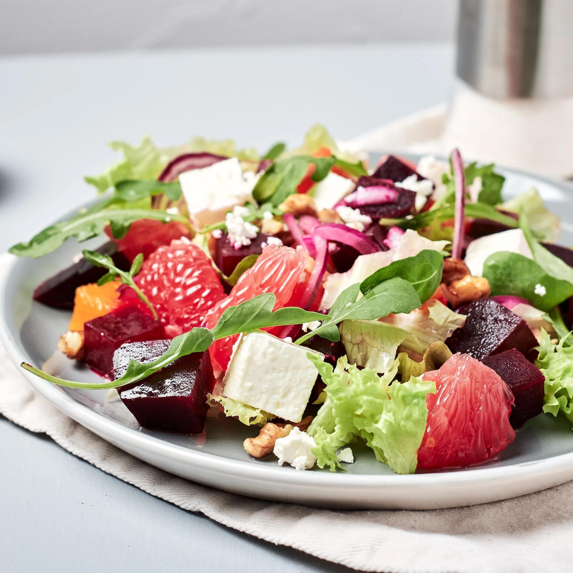 Beet Salad on a white plate on top of a grey table