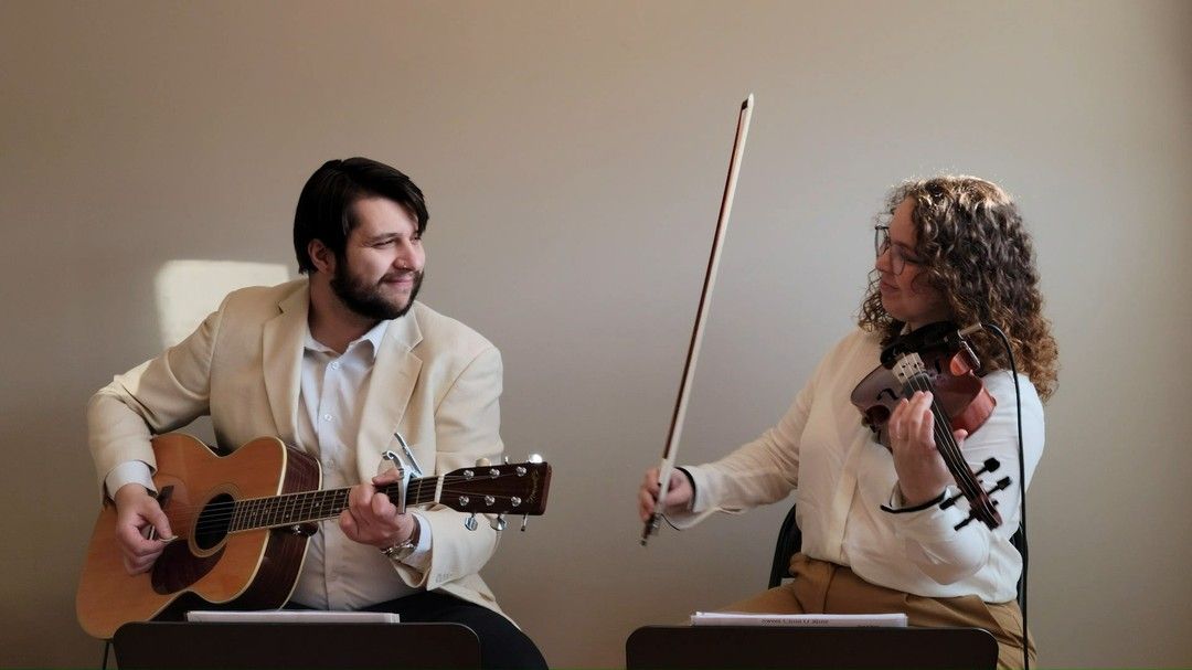 Steve and Sarah of Sine Verba holding their instruments