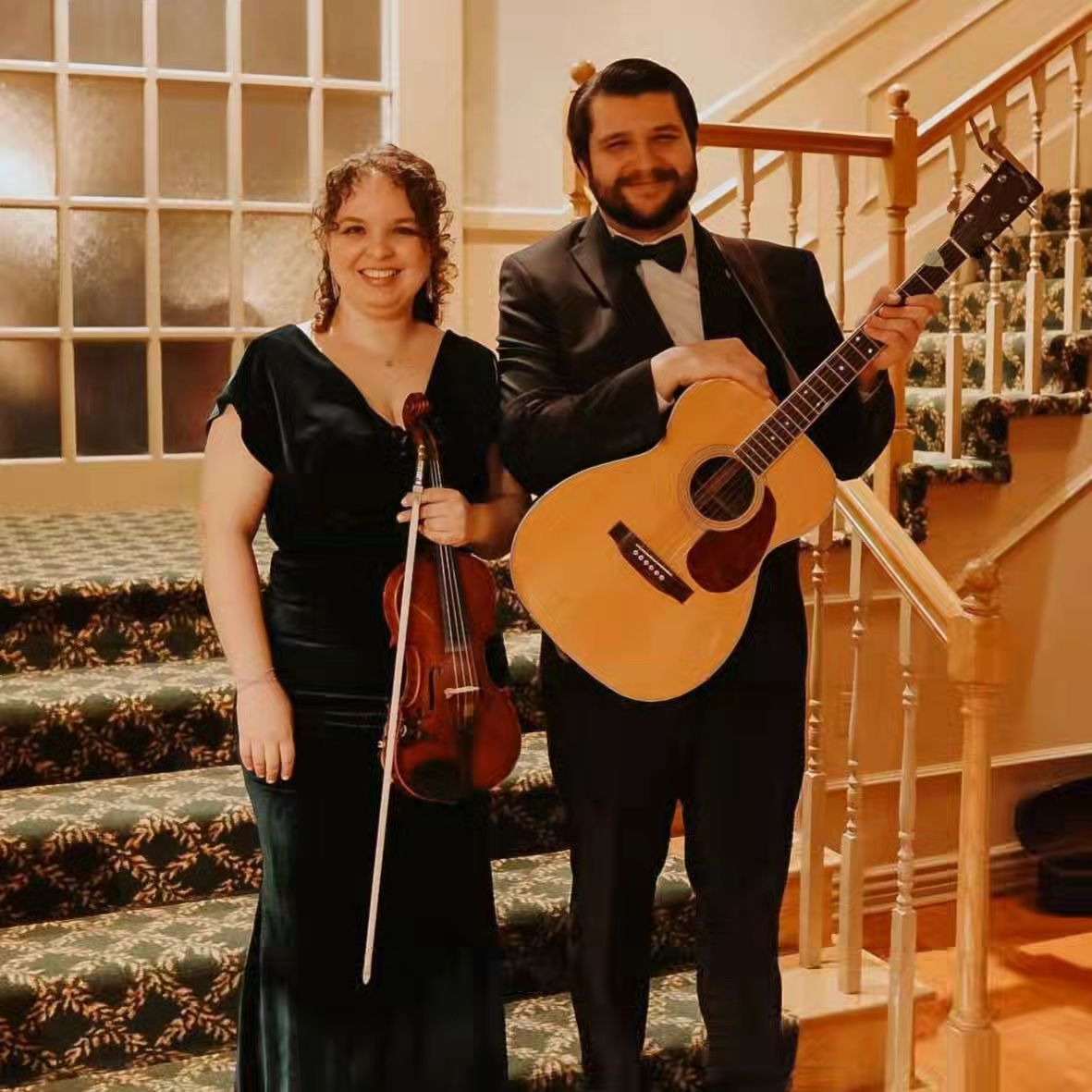 Steve and Sarah of Sine Verba holding their instruments