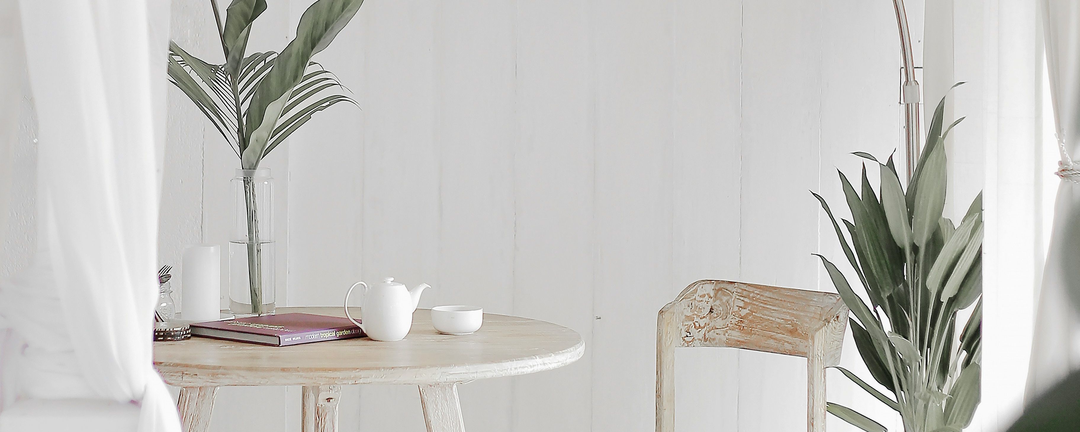 a white room with a round table and chairs