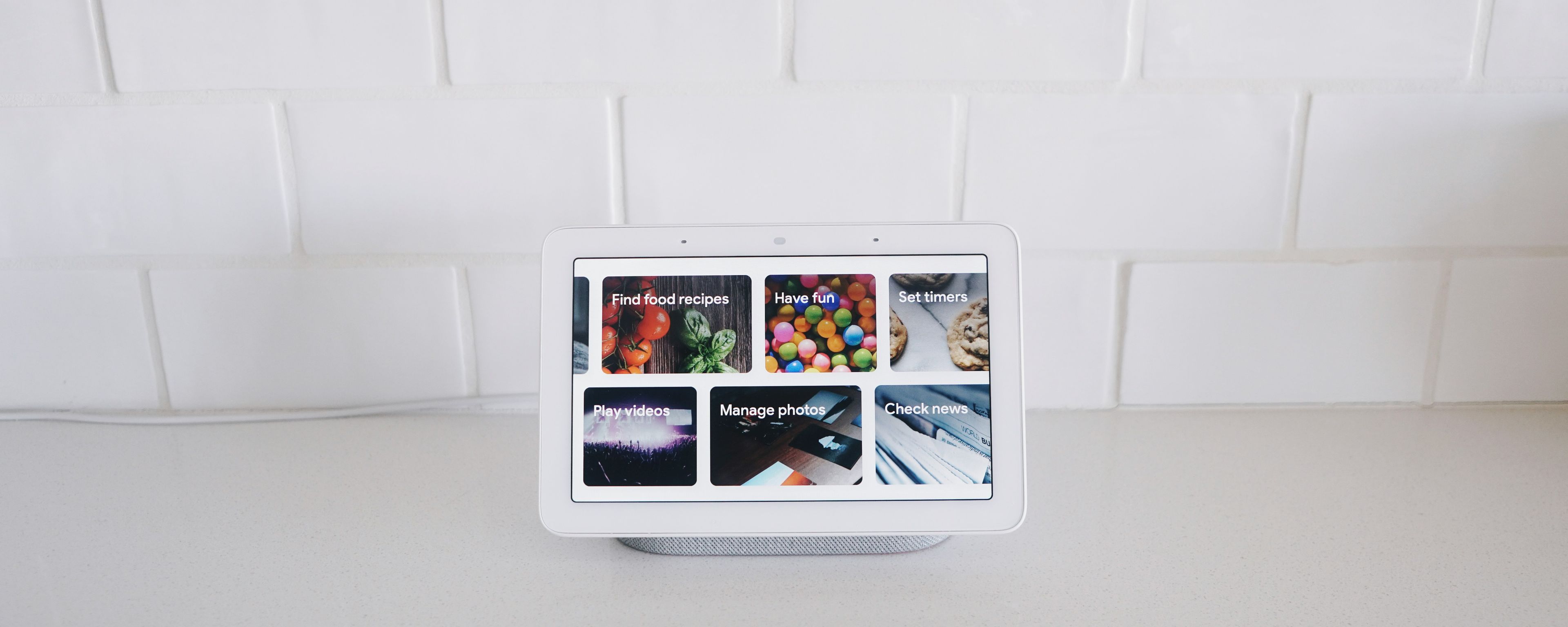 a google nest hub is sitting on top of a white counter .