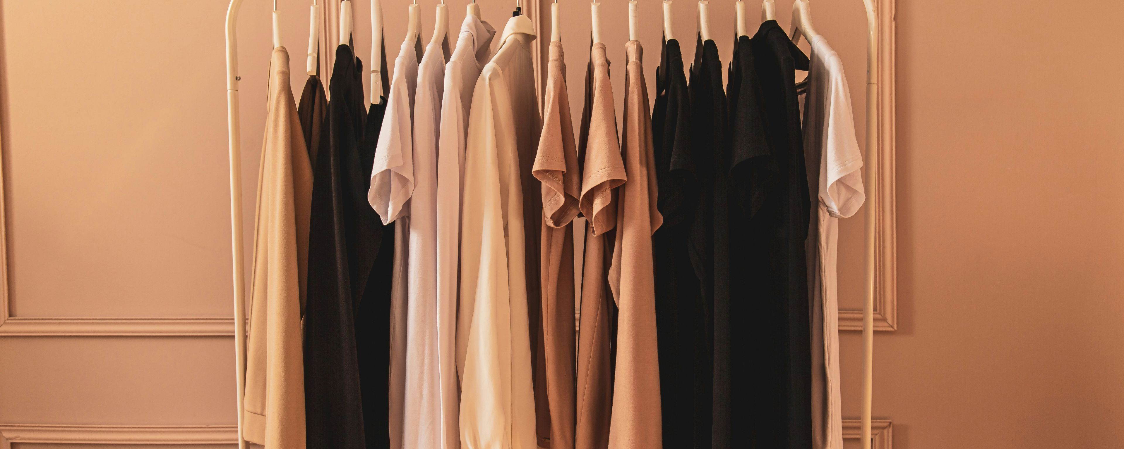 a clothes rack filled with hanging clothing