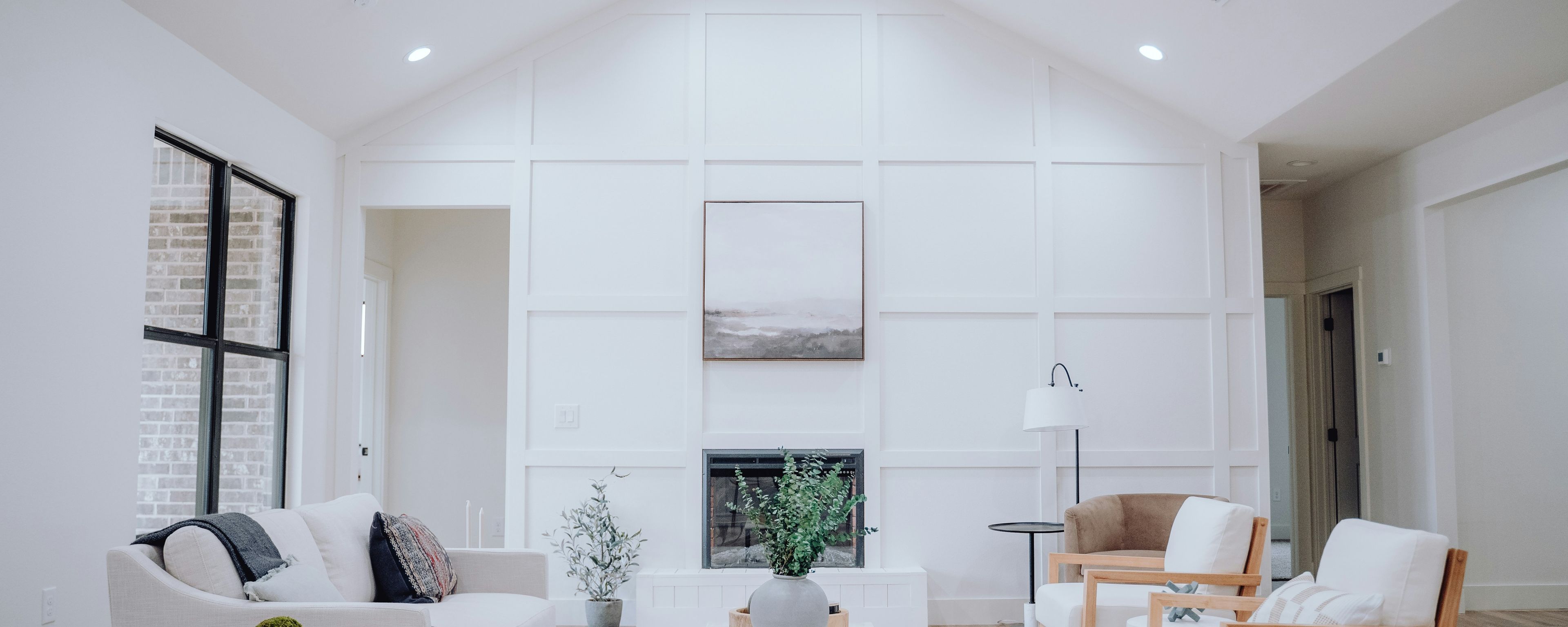 bright living room with white walls and neutral furniture