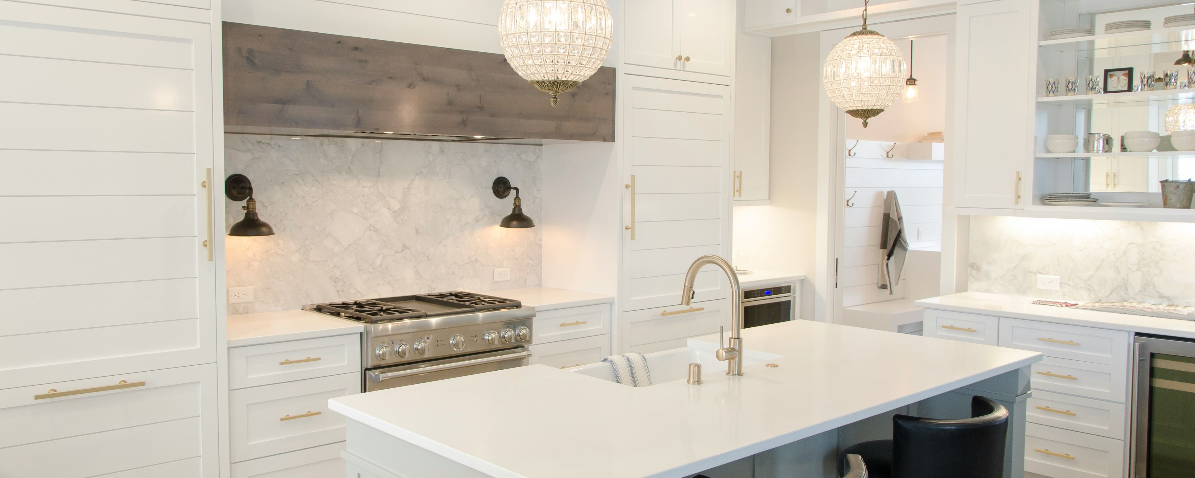 a white kitchen with an island in the center