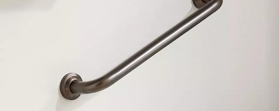 metal grab bar mounted to a wall