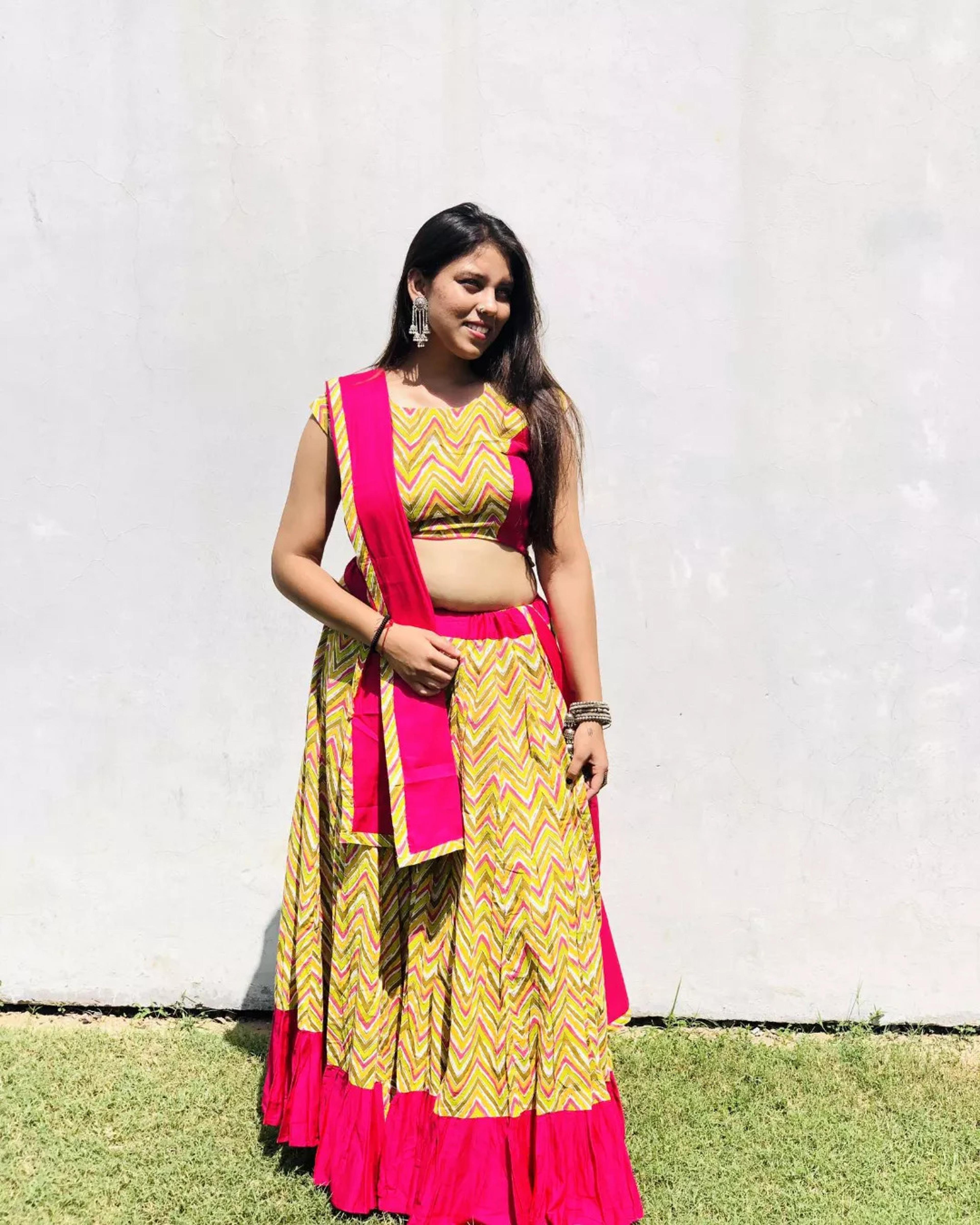 Yellow chevron print chaniya choli with a rani pink border and dupatta