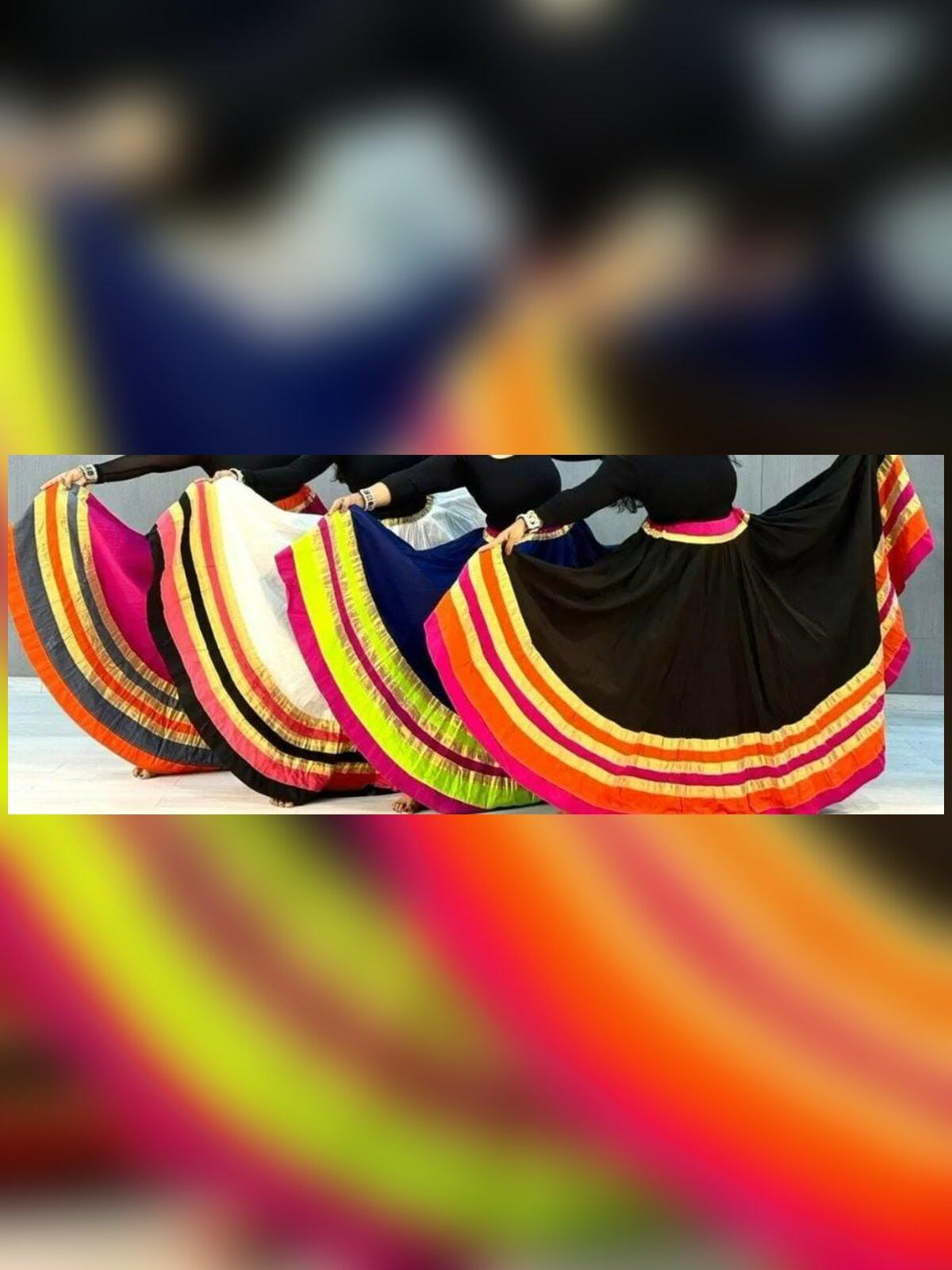 A row of Jaipuri cotton chaniyas fanned out to show their layered golden borders