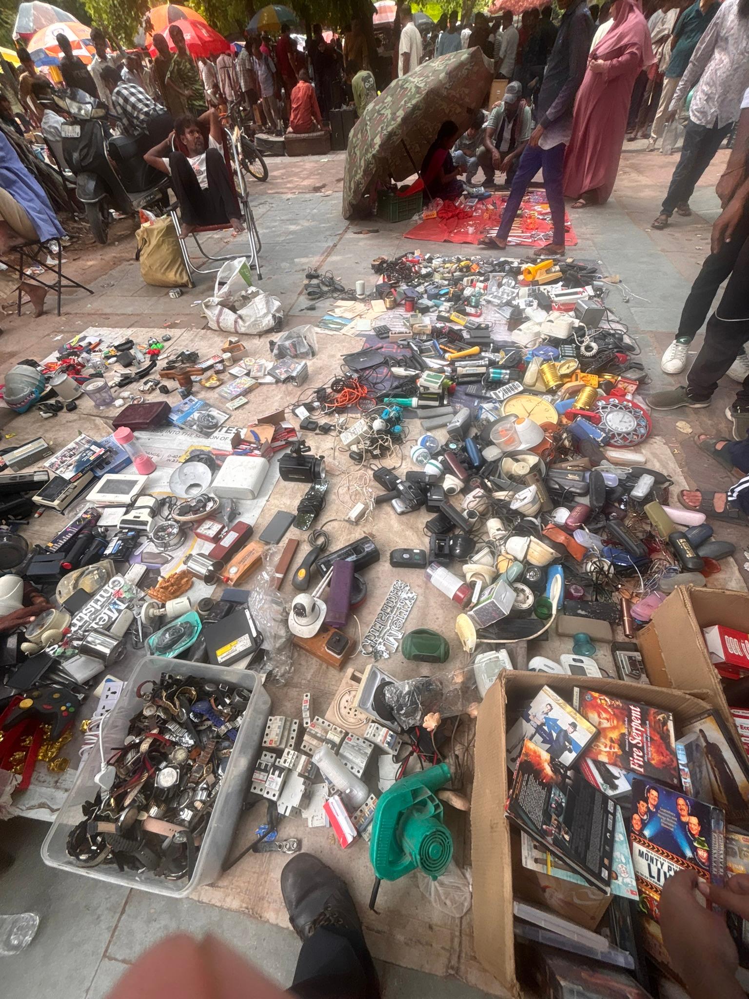 Second-hand goods laid out on the ground at the Ravivari Sunday market
