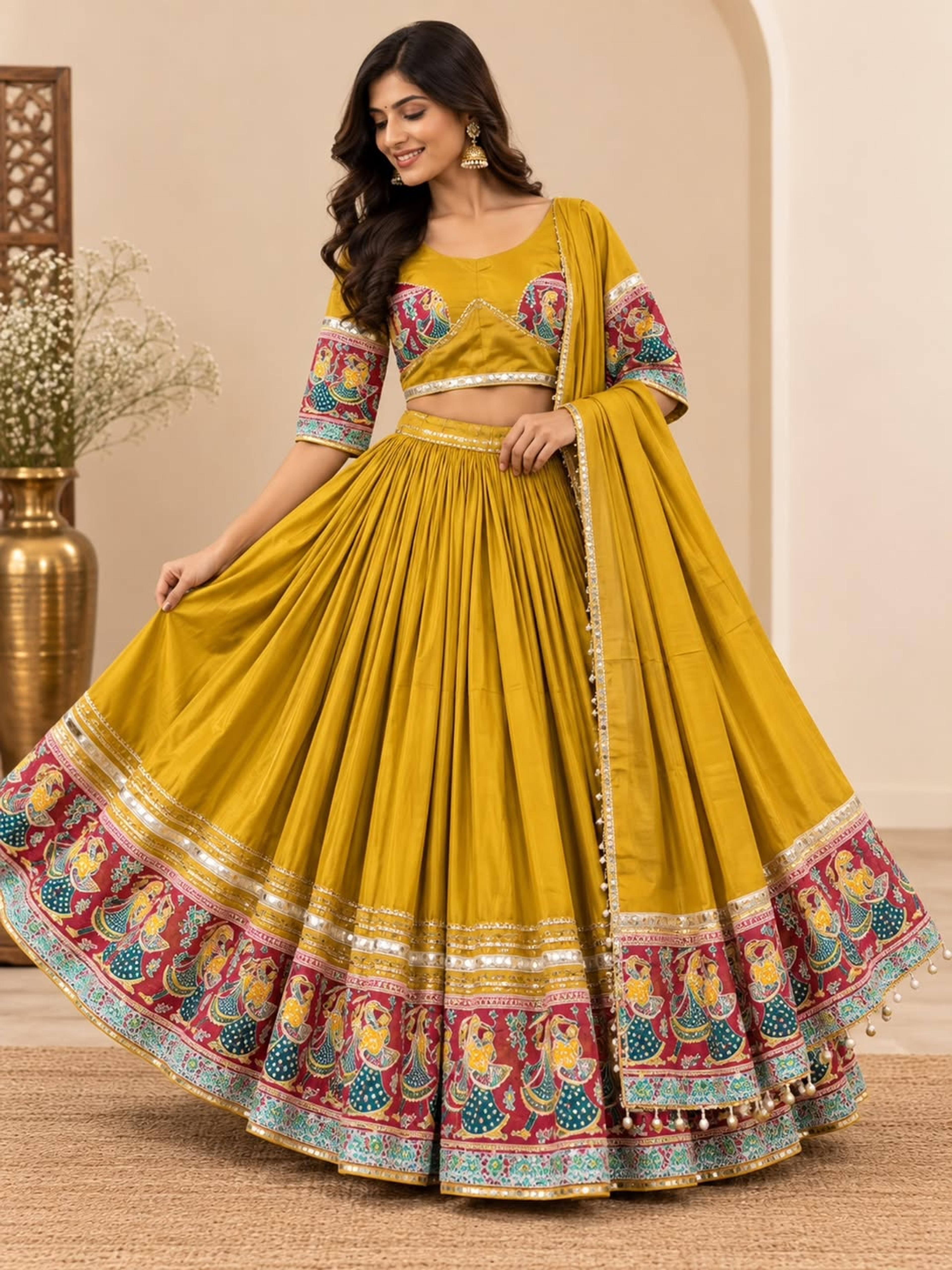 Model in a mustard Roman silk chaniya choli with a wide printed border and matching dupatta