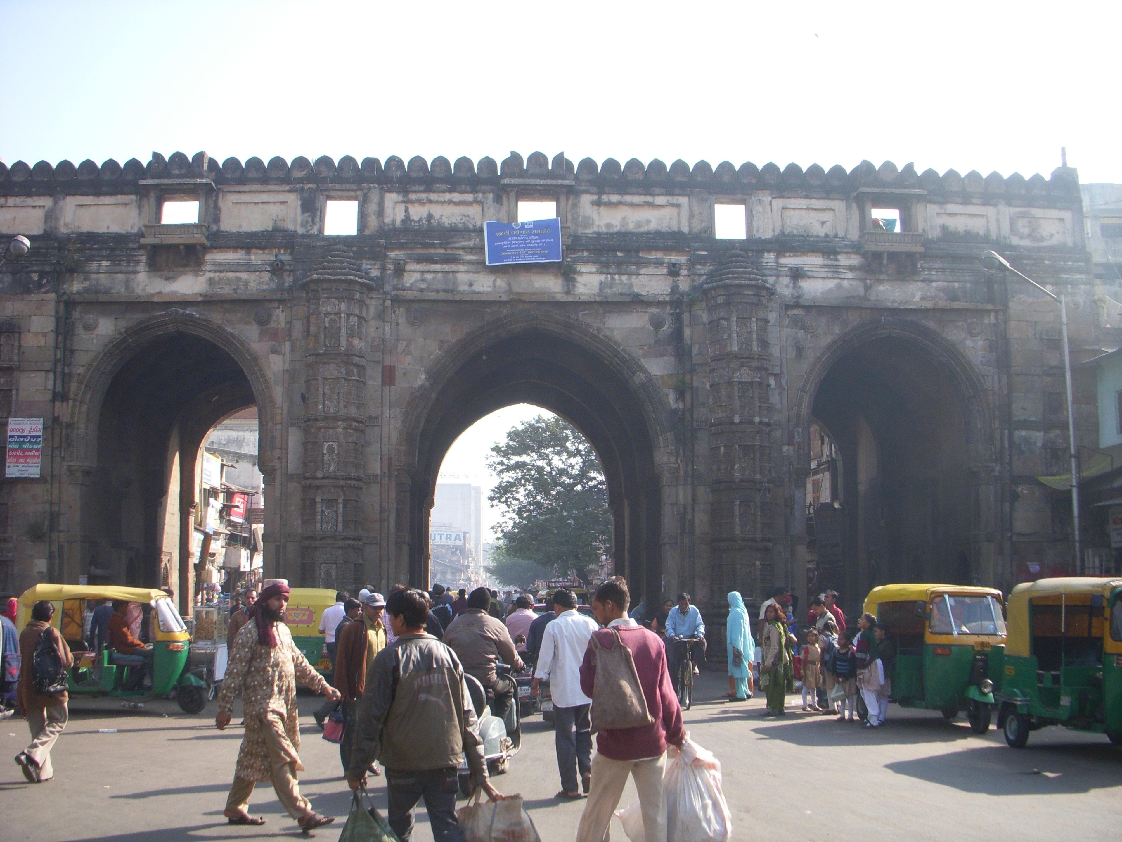 Shoppers passing through the three arches of Teen Darwaza, Ahmedabad