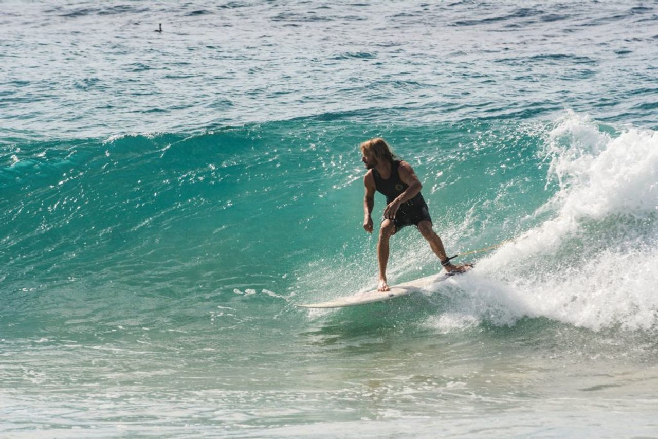 Man Surfing On Body Of Water