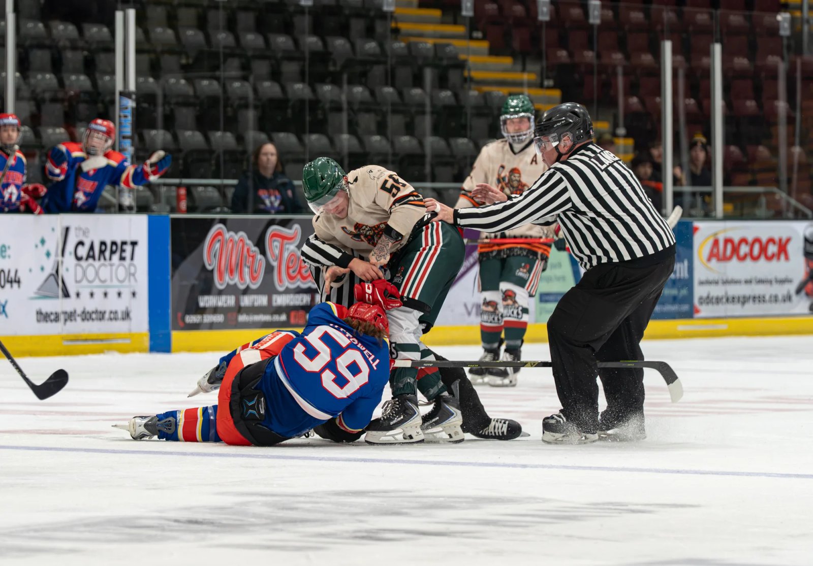 Officials intervene during a fight in Cardiff's Halloween home game against Slough Spitfires.