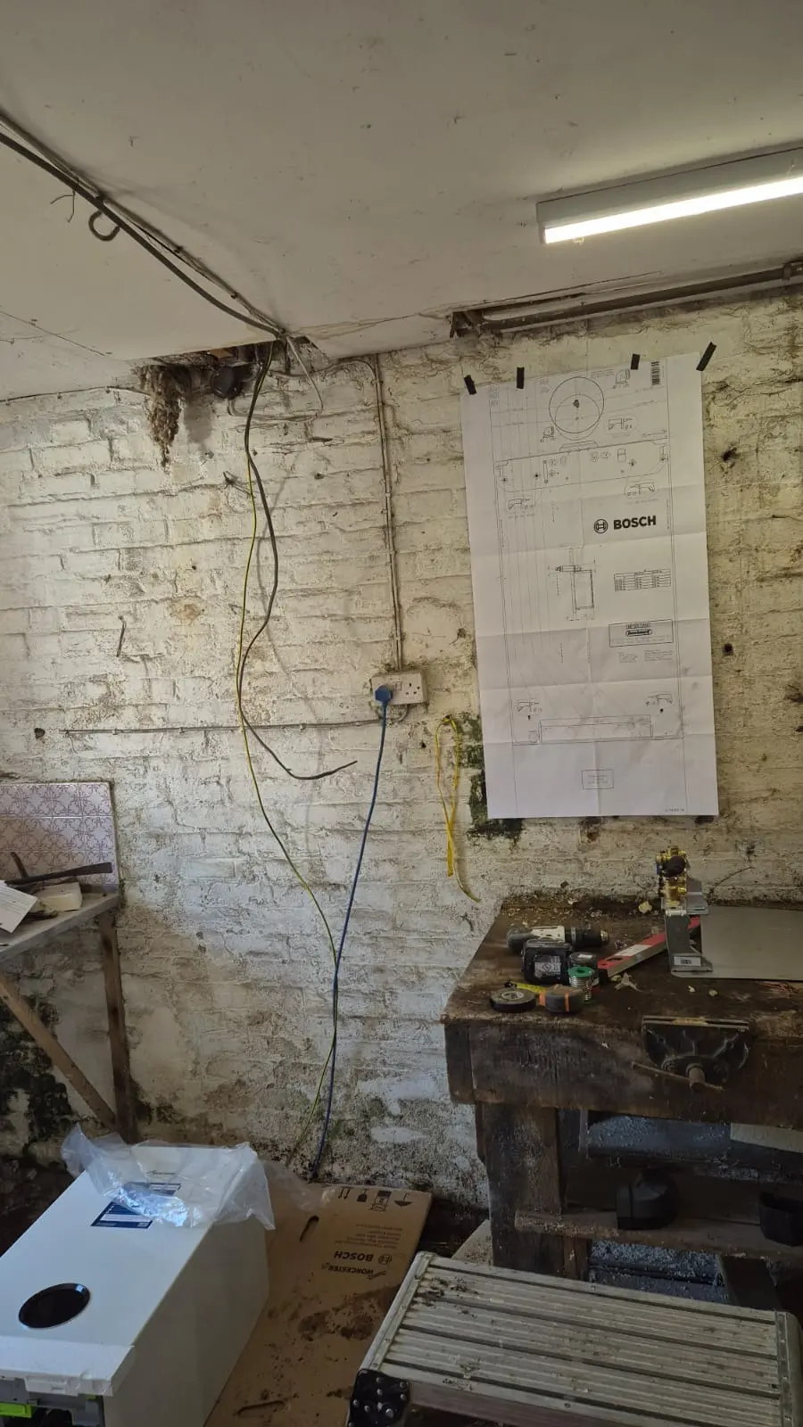 Worcester Bosch installation template marked up on the cellar wall before fitting