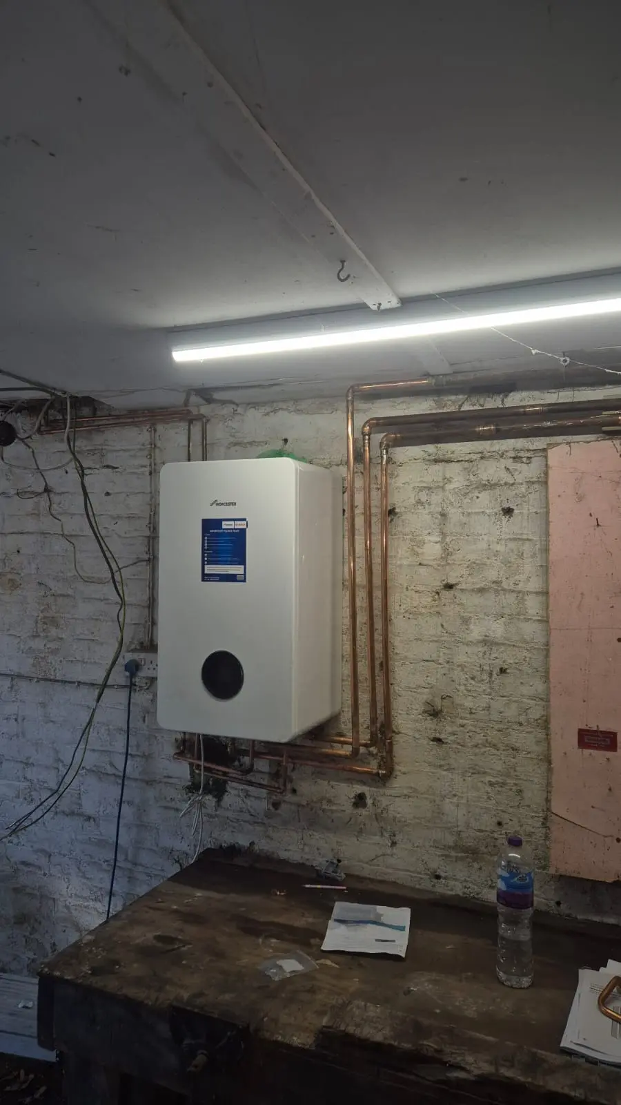 Vaillant combi boiler in its original position on an internal wall before relocation, Wimbledon