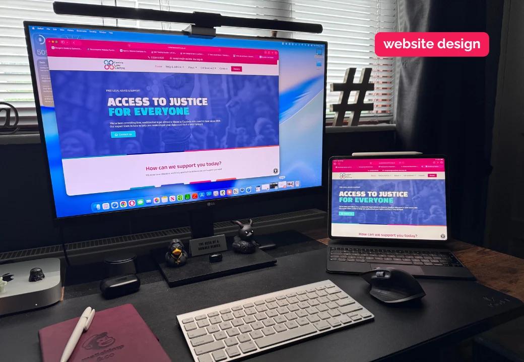 web design carlisle - desk at fecking creative with clients website open on screen and iPad