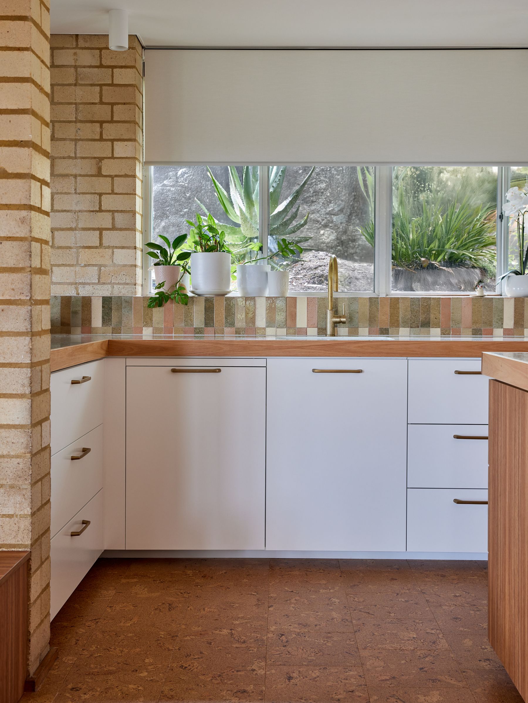 Kitchen with timber benchtop and brass tap